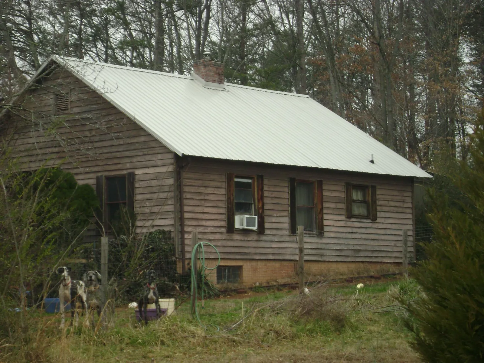 White metal roof on an old wood sided farmhouse, from a Metal Roof Installation job in Rockvale